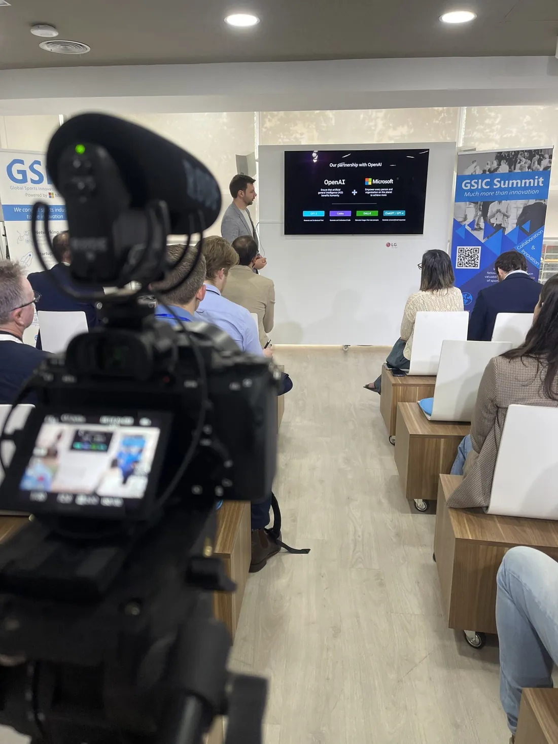 Camera filming a talk at the GSIC Summit